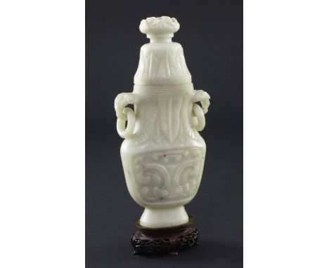 A Chinese greyish white bowenite jade archaistic vase and cover, 20th century, 17cm, wood stand A Chinese greyish white bowen