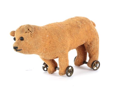 Early 20th Century Miniature Bear on Wheels, with boot button eyes, in brown worn plush, stitched nose, straw filled on gilt 