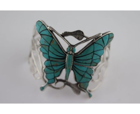 A turquoise and silver butterfly bangle, the central butterfly turquoise set measuring approximately 55mm by 60mm, openwork s