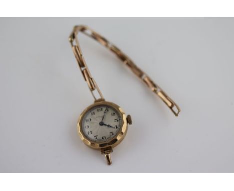 A ladies 9ct gold cased wristwatch, the engine turned silvered enamel dial signed Thomas Russell & Son, black Arabic numerals