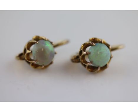 A pair of precious white opal unmarked yellow gold drop earrings, the round cabochon cut opals with diameter measuring approx