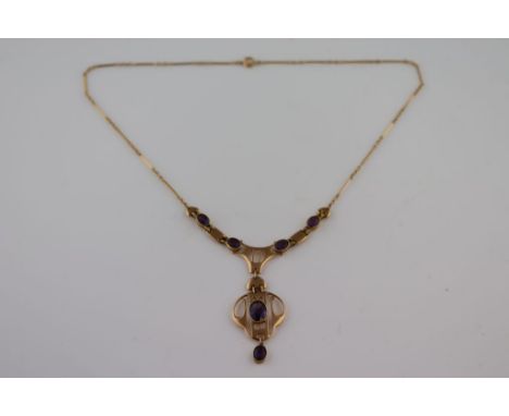 Murrle Bennett: an Arts and Crafts Secessionist style amethyst 15ct yellow gold Murrle Bennett pendant necklace, the linear o