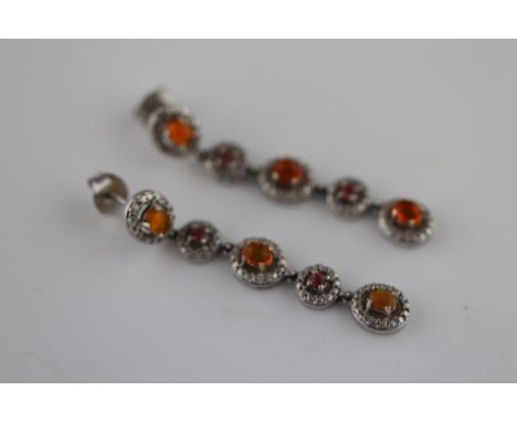 A pair of fire opal and red stone silver drop stud earrings, comprising five cluster style links, alternate set with oval cab