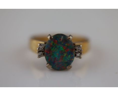  A black opal doublet and diamond 9ct yellow gold and white gold set ring, the central black opal doublet measuring approxima