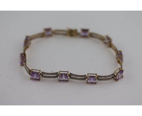 An amethyst and diamond 14ct yellow gold bracelet, ten square cut claw set amethysts measuring approximately 5.5mm by 5.5mm, 