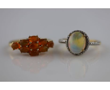 An opal silver gilt dress ring, the oval cabochon cut precious white opal measuring approximately 10mm by 8mm, claw settings,