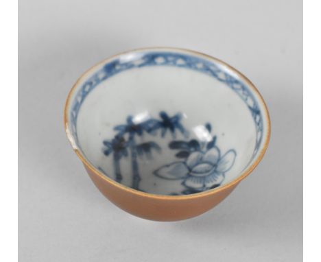 An 18th Century Chinese Porcelain Nanking Cargo Tea Bowl with Inner Blue and White Floral Decoration and Oxidised Outer, with