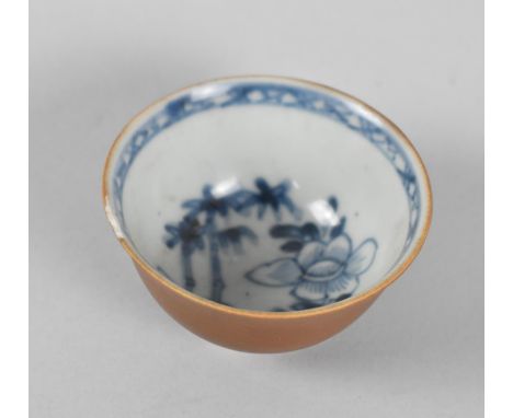 An 18th Century Chinese Porcelain Nanking Cargo Tea Bowl with Inner Blue and White Floral Decoration and Oxidised Outer, with