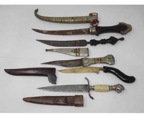 Four Eastern Daggers and a European Dagger with 'claw and ball' pommel 