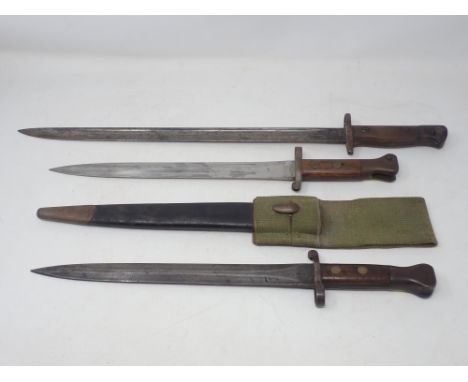 An 1888 Pattern Bayonet dated 1897 on scabbard and ricasso complete in a webbing frog, another similar lacking scabbard dated