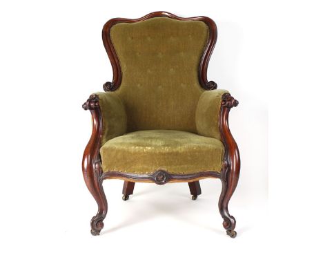 A Victorian mahogany and button upholstered armchair on scrolled front feet CONDITION REPORT: May require reupholstery, tired