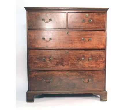 A George III mahogany oversized chest of two short over three long graduated drawers on bracket feet, bearing a paper label v