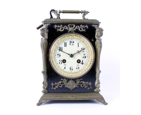 A 19th century French mantel clock, the enamelled face with Arabic numerals, within a brass mounted and ebonised case, h. 23 