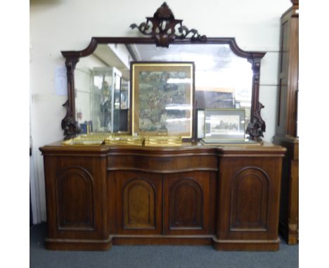 A Victorian mahogany sideboard, the mirrored panel over a bow front and an arrangement of four doors and one drawer on a plin