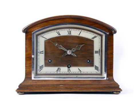 A 20th century chiming mantel clock, the brass and walnut face with Roman numerals within a walnut case of domed form, h. 22 