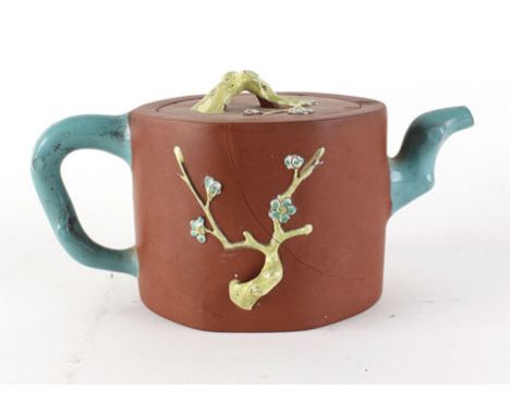 A late 19th/early 20th century Chinese terracotta teapot and cover relief decorated with blossoming branches, four character 