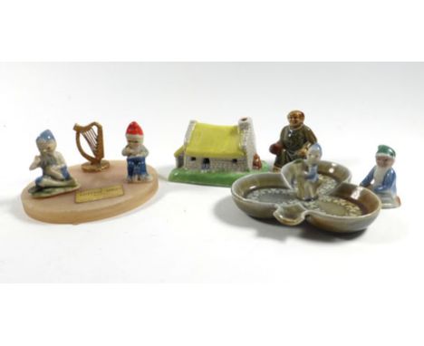 A group of Irish Wade items including Leprechaun figures, other figures, a ring tray and three cottages 