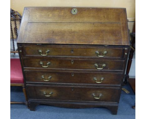 A George III oak and crossbanded bureau, the fall front over four long graduated drawers on bracket feet, w. 91 cm CONDITION 