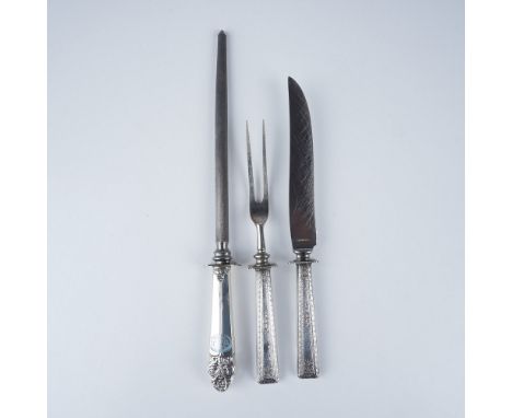 Elegant three-piece carving set featuring sterling silver handles with intricate detailing and stainless steel components. Th