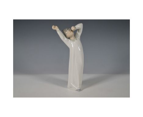 Nao by Lladro porcelain figurine titled Boy Yawning (1004870), sculpted by Salvador Debón. This charming piece depicts a youn