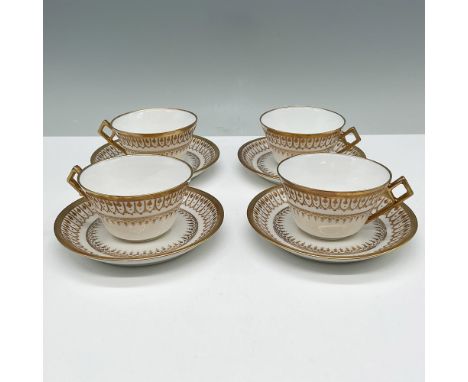 Elegant set of four B &amp; H Limoges porcelain teacups and saucers featuring a sophisticated gold gilt pattern. The intricat