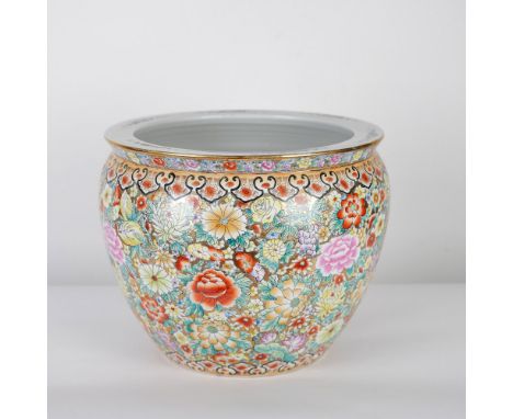 A large and exquisitely decorated Chinese Lingnan Famille Rose porcelain fishbowl planter, featuring a dense and colorful flo