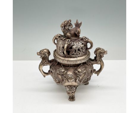 A finely cast Chinese bronze censer featuring elaborate dragon and foo dog motifs. The censer stands on three legs, each ador