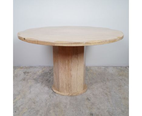 A striking mid-century modern round dining table crafted from travertine marble in a warm beige tone with natural veining. Th