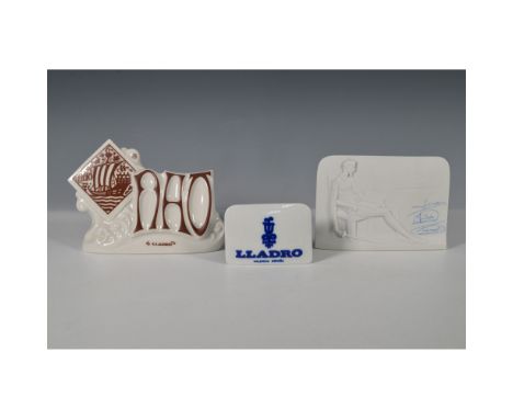 This 3-piece set of Lladro porcelain advertising signs includes two Lladro and one Nao display plaques, crafted to showcase t