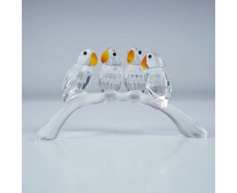 A charming Swarovski crystal figurine featuring four baby Lovebirds perched on a frosted three-pronged arch branch. Part of t