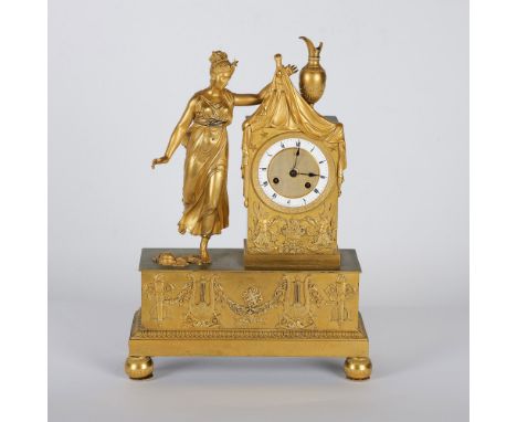 An exquisite French Empire style gilt bronze mantel clock, featuring a neoclassical allegorical female figure draped in flowi
