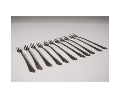 A vintage set of eleven (11) Winthrop silver-plated seafood or cocktail forks, showcasing elegant craftsmanship. Each fork fe