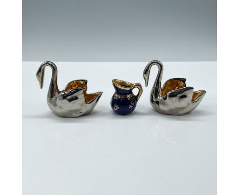 Includes two elegant swan-shaped pieces with a shiny silver exterior and a vibrant gold-tone interior and a cobalt blue pitch