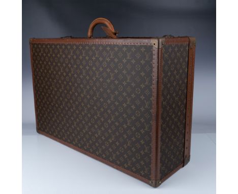 Vintage Louis Vuitton monogram canvas hard-sided suitcase, featuring the iconic LV monogram design, reinforced leather trim, 