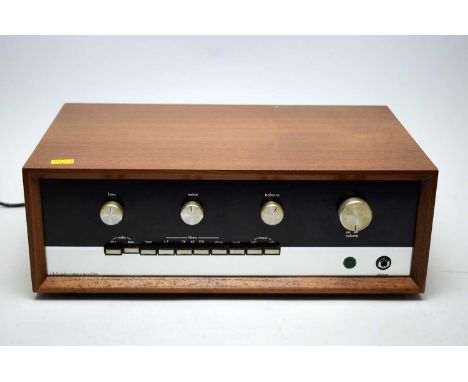 A Sugden A48 MK1 stereo amplifier, in teak sleeve.