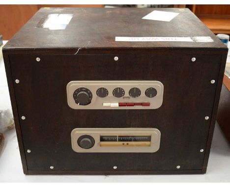 A Quad 22 amplifier and a Quad FM1 tuner, in stained-pine case fitted brass carrying handles.