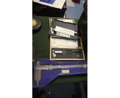 A Collection of Three Digital Calipers and a Manual Example 