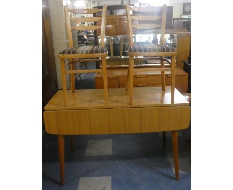 A 1960's Drop Leaf Kitchen Table and Two Ladder Back Chairs 