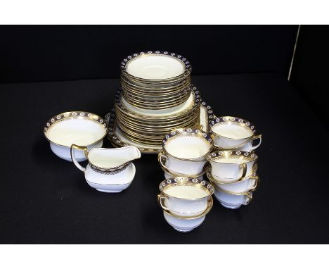 Aynsley tea set with blue and gilt foliate borders, consisting of eleven teacups, twelve saucers, twelve tea plates, two cake