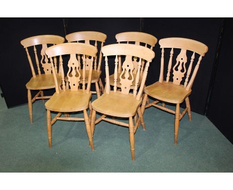 Set of six beech farmhouse style dining tables with curved cresting rails, pierced and spindle turned splat backs, solid dish