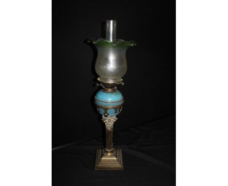 19th Century oil lamp, with a green and frosted glass shade above a blue pottery reservoir and a gilt metal base, 62cm high