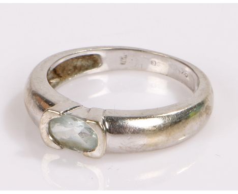 9 carat white gold ring, set with a pale blue stone, together with a 9 carat gold earing catch, total weight 2.4 grams