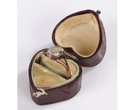 Yellow metal ring, with a pale blue stone, housed within a heart shaped jewellery box, (2)