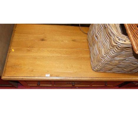 A contemporary joined light oak low rectangular coffee table, having three short drawers, length 120cm 