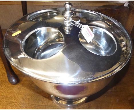 A contemporary polished chrome circular four-division footed champagne cooler, with removable finialled cover, dia.37cmCondit