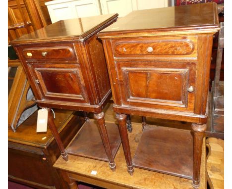 A pair of early 20th century French mahogany single door two-tier pot cupboards, each having single upper drawers with cerami