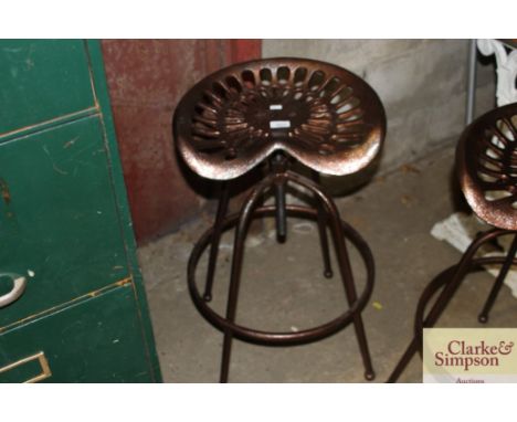 A tractor seat stool (132)