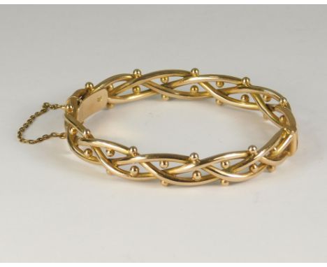 GOLD BANGLE. A Victorian 15ct. gold bangle of interwoven design. Original fitted case for Birch &amp; Gaydon, London. Approx.