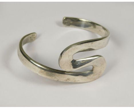 MEXICAN SILVER. A Mexican solid silver bangle, stamped DDD.