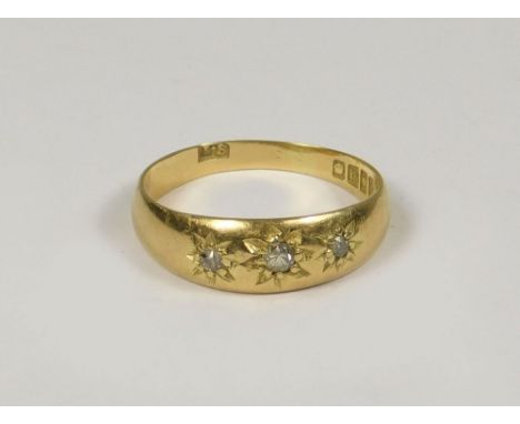 GOLD RING. A late Victorian 18ct. gold three stone diamond ring. Size P.